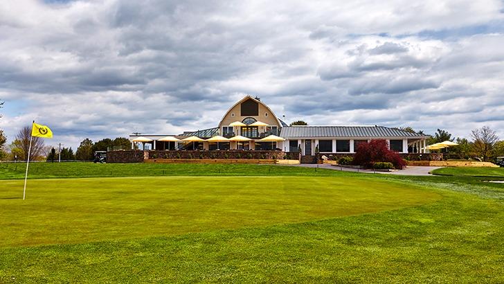 Panoramic view of a lush green golf course at Chantilly National Golf & Country Club. Smooth