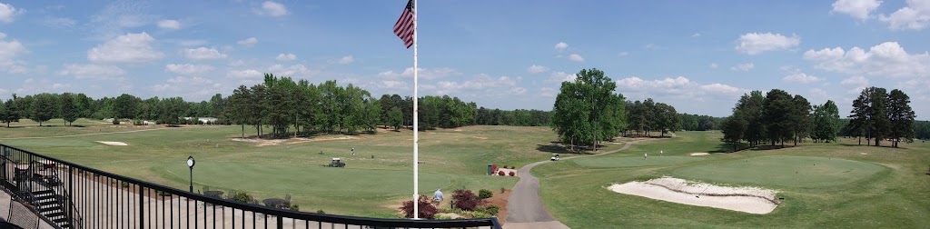 Panoramic view of a lush green golf course at Cherokee National Golf and Recreational Club. Smooth