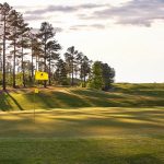 Panoramic view of a lush green golf course at Cherokee Valley Course and Club. Smooth