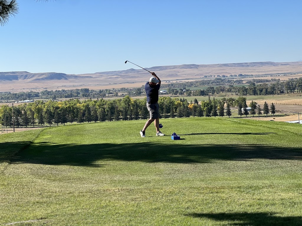 Panoramic view of a lush green golf course at Choteau Country Club. Smooth