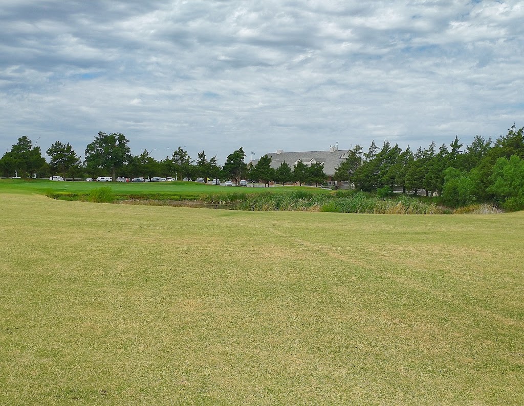 Panoramic view of a lush green golf course at Cimarron National Golf Club. Smooth