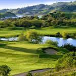 Panoramic view of a lush green golf course at Cinnabar Hills Golf Club. Smooth