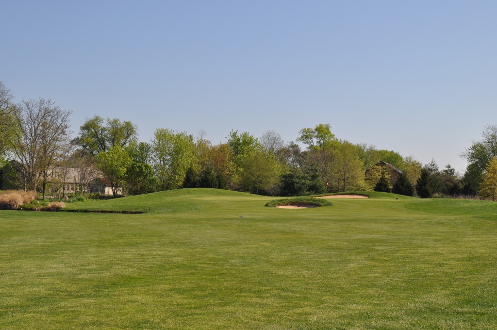 Panoramic view of a lush green golf course at Clustered Spires Golf Club. Smooth