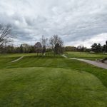 Panoramic view of a lush green golf course at Cochecho Country Club. Smooth