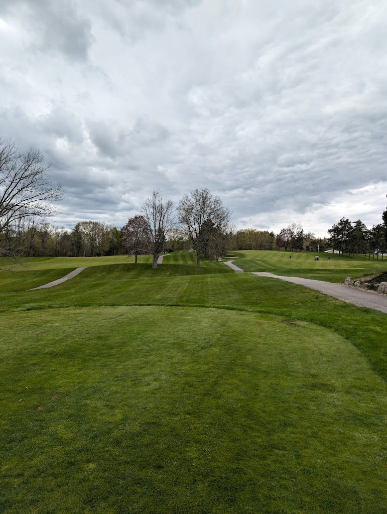 Panoramic view of a lush green golf course at Cochecho Country Club. Smooth