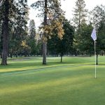 Panoramic view of a lush green golf course at Coeur d'Alene Public Golf Club. Smooth