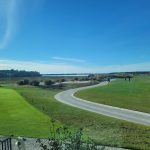 Panoramic view of a lush green golf course at Colleton River Club. Smooth