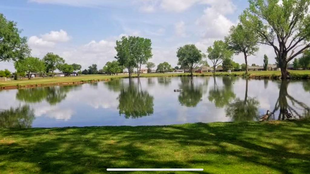 Panoramic view of a lush green golf course at Colonial Park Golf Course. Smooth