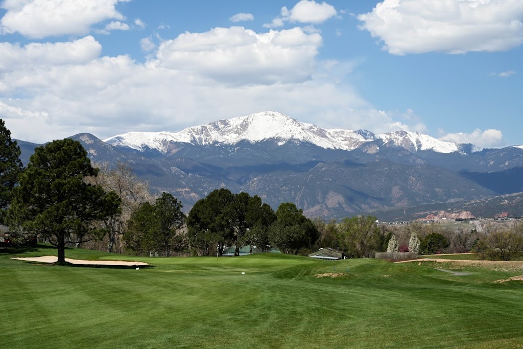 Panoramic view of a lush green golf course at Colorado Springs Country Club. Smooth