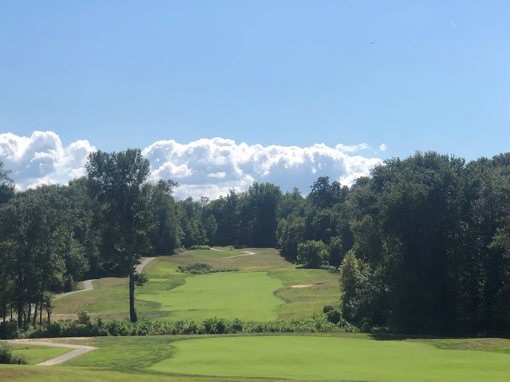 Panoramic view of a lush green golf course at Compass Pointe Golf Courses. Smooth