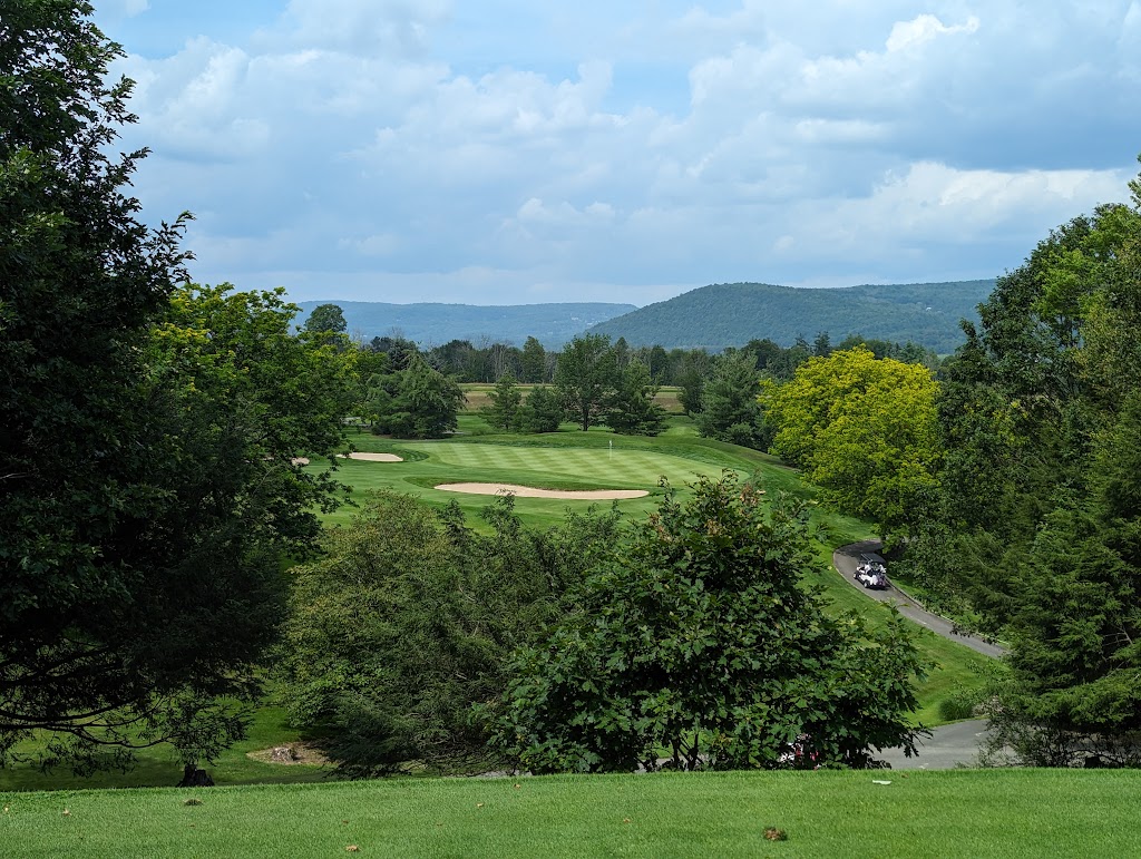 Panoramic view of a lush green golf course at Conklin Players Club. Smooth