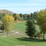 Panoramic view of a lush green golf course at Cottonwood Country Club. Smooth