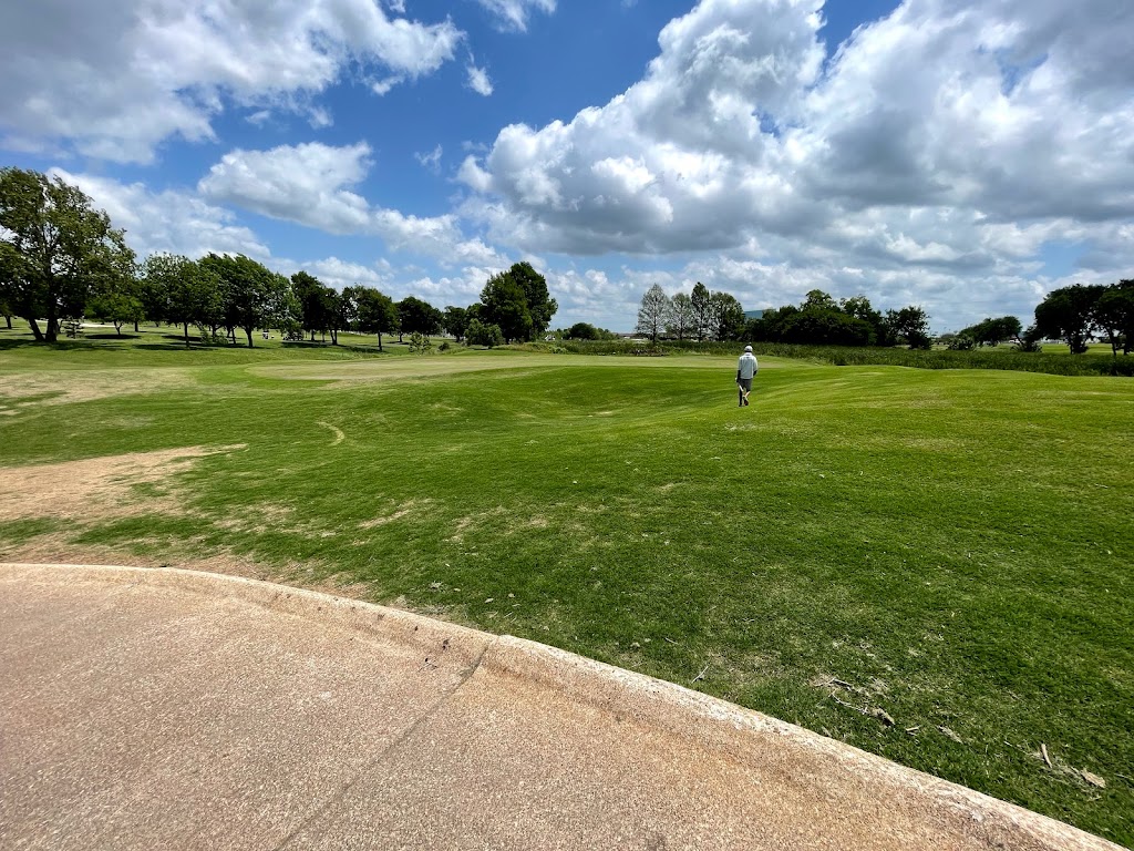 Panoramic view of a lush green golf course at Cottonwood Creek Golf Course. Smooth