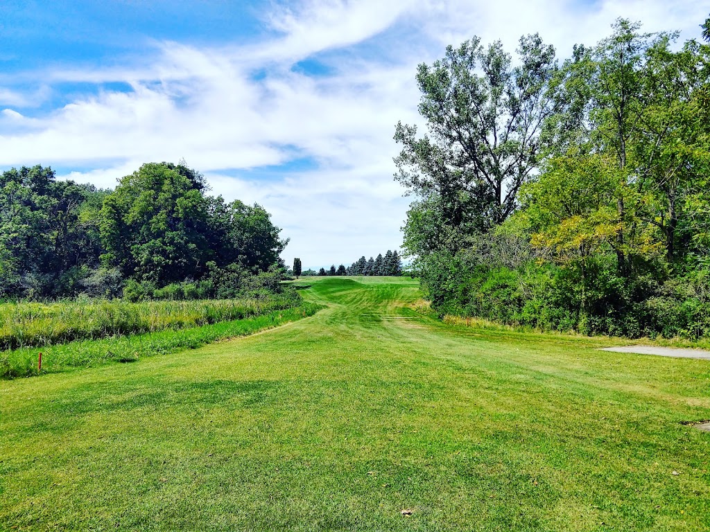 Panoramic view of a lush green golf course at Country Club Estates Golf Course. Smooth