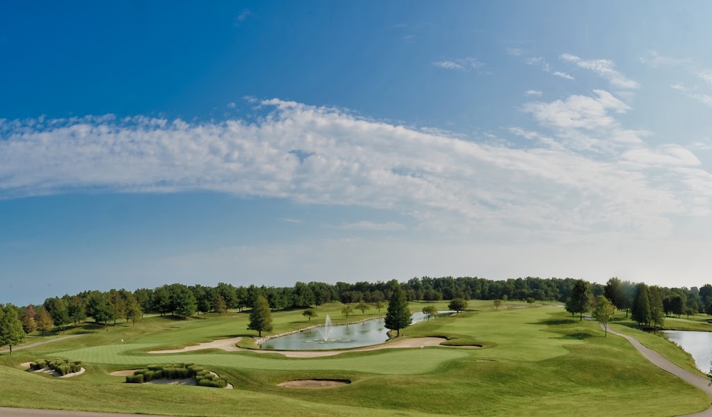 Panoramic view of a lush green golf course at Covered Bridge Golf Club. Smooth