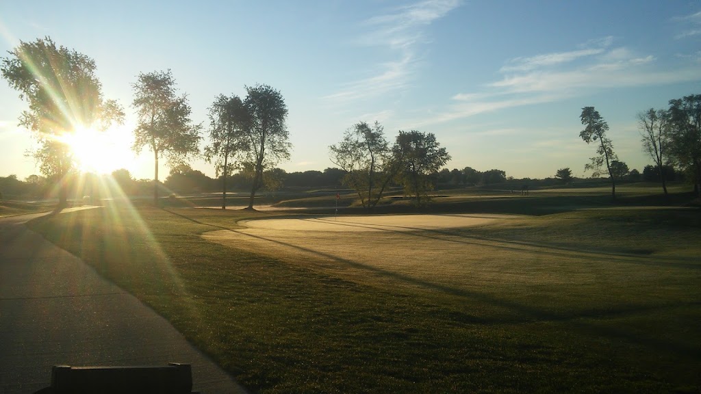 Panoramic view of a lush green golf course at Coyote Creek Golf Club. Smooth