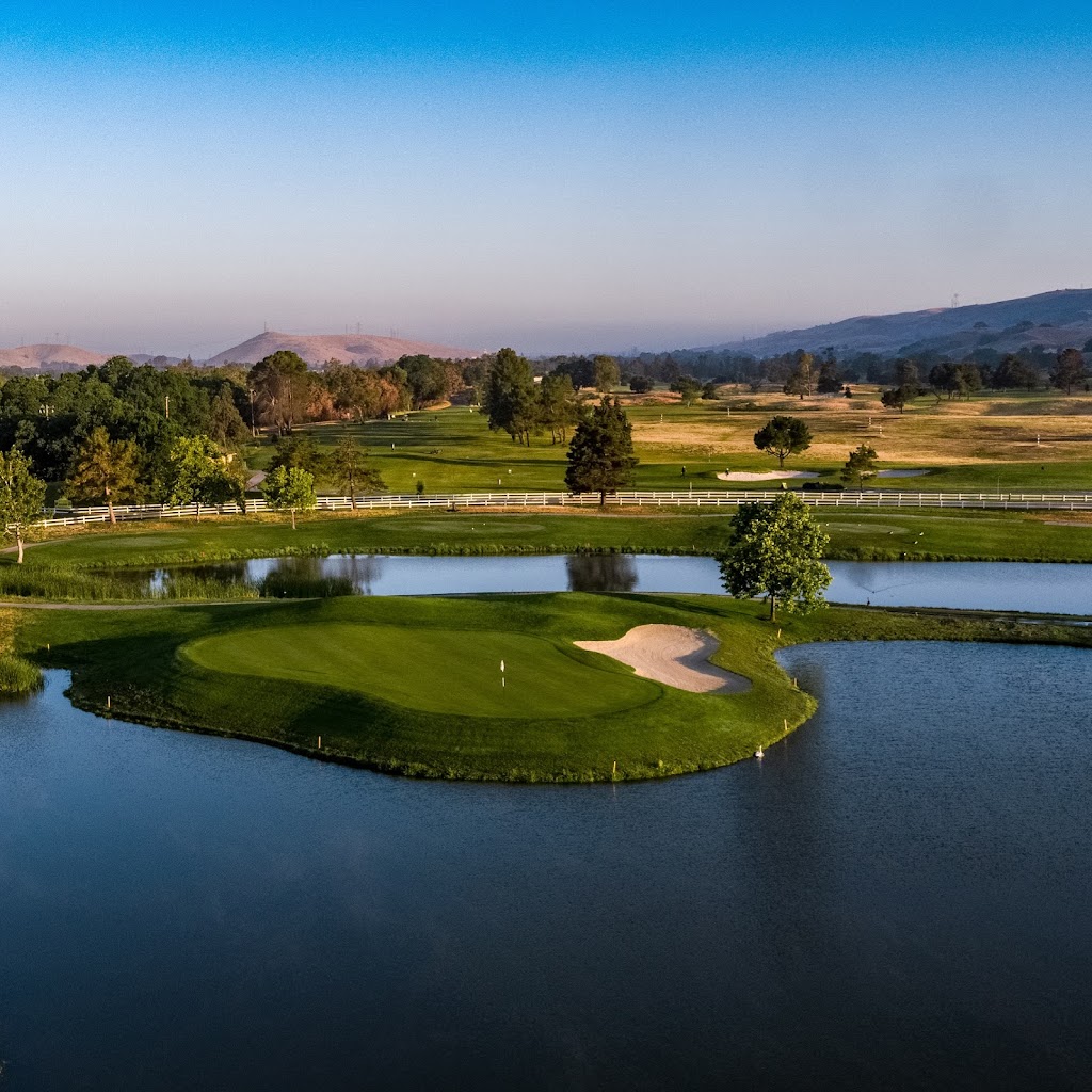 Panoramic view of a lush green golf course at Coyote Creek Golf Club. Smooth