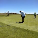 green grass with the flag in the hole.