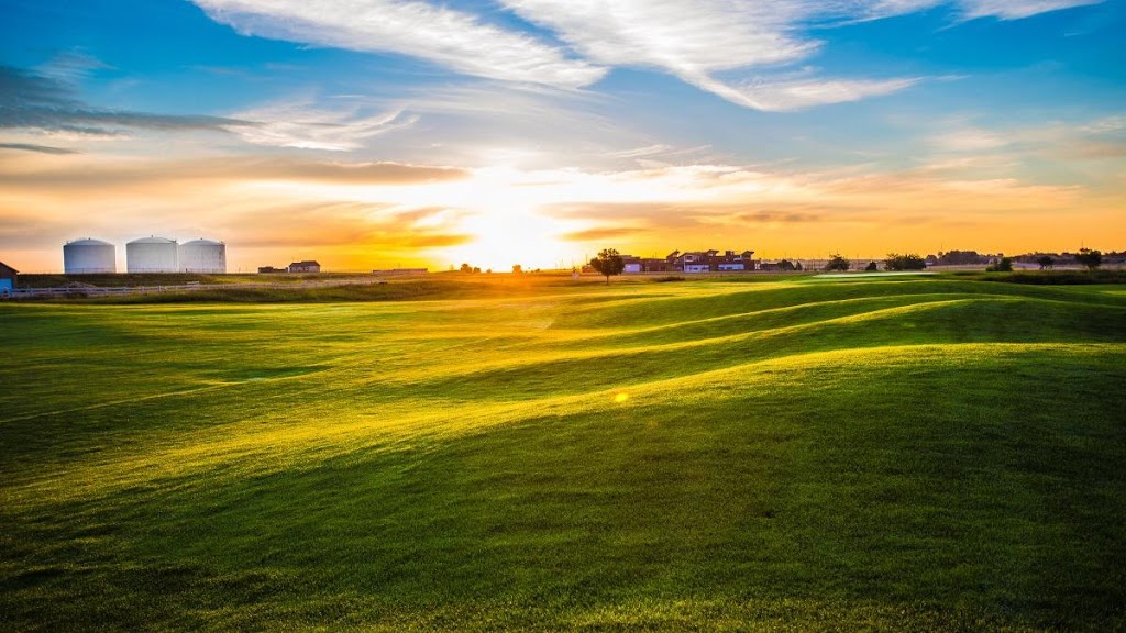 Panoramic view of a lush green golf course at Coyote Creek Golf Course. Smooth