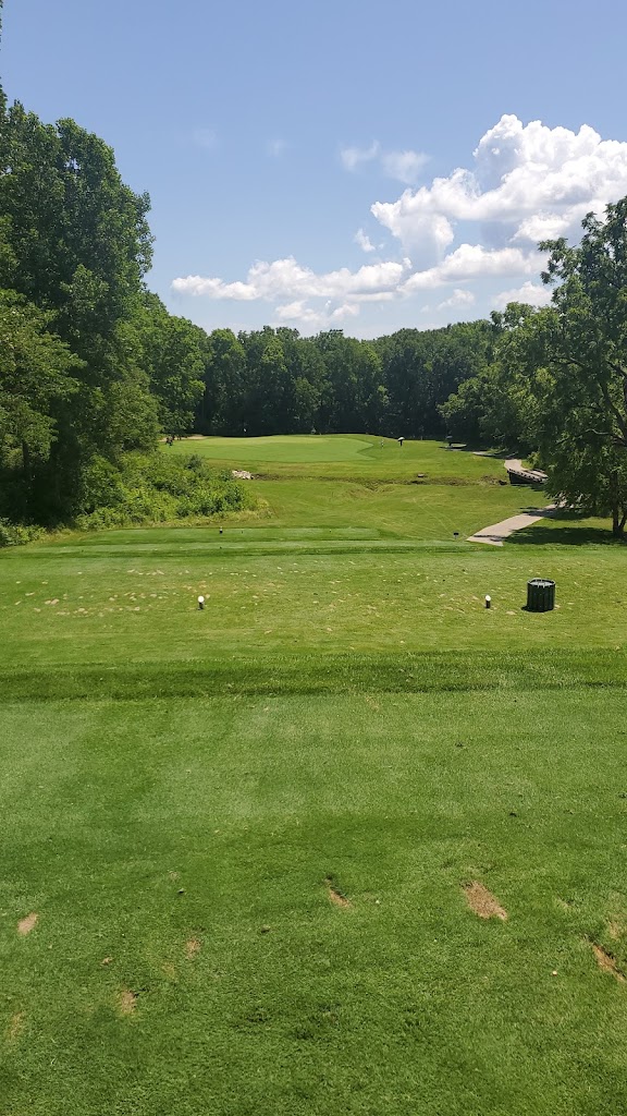 Panoramic view of a lush green golf course at Coyote Crossing Golf Club. Smooth