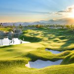 Panoramic view of a lush green golf course at Coyote Springs Golf Club. Smooth