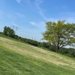 Panoramic view of a lush green golf course at Crooked Creek Golf Club. Smooth