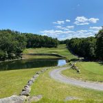 Panoramic view of a lush green golf course at Crosswinds Golf Club. Smooth