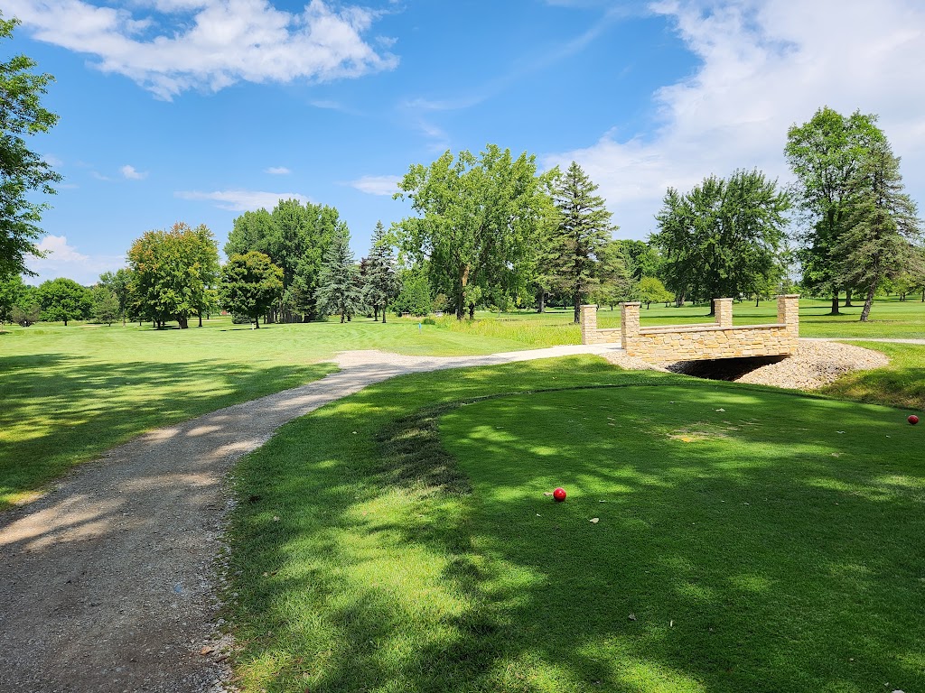 Panoramic view of a lush green golf course at Crystal Springs Golf Course. Smooth