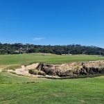 Panoramic view of a lush green golf course at Cypress Point Club. Smooth