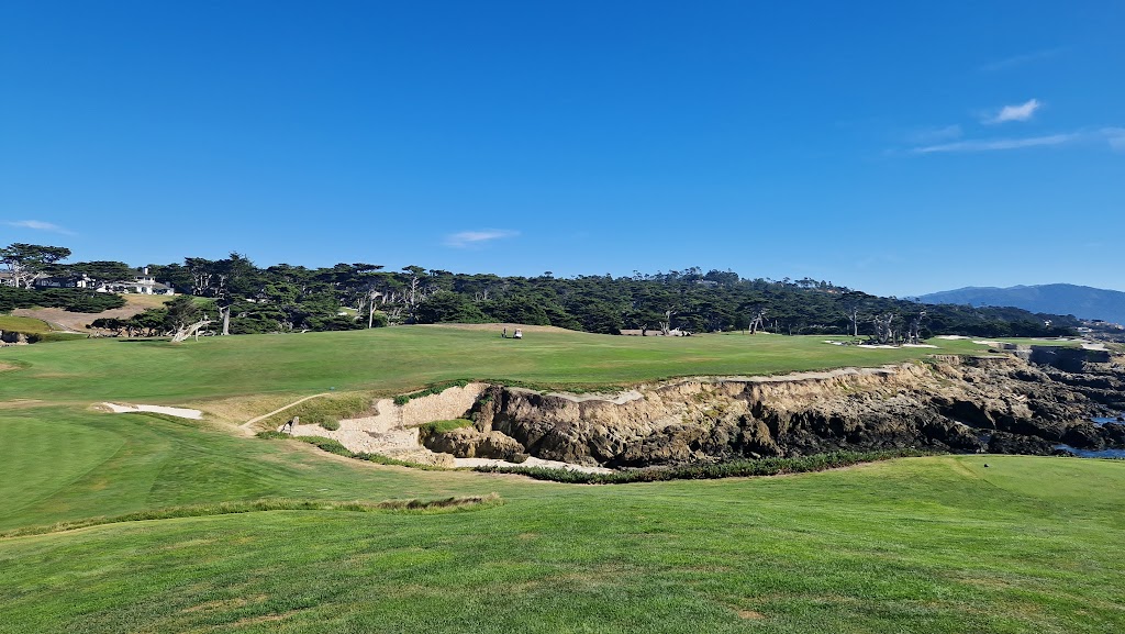 Panoramic view of a lush green golf course at Cypress Point Club. Smooth