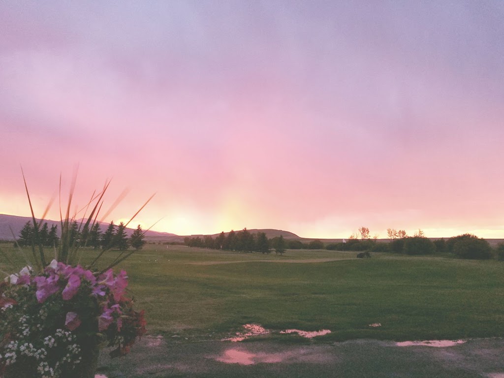 Panoramic view of a lush green golf course at Deer Lodge Golf Course (aka Deer Park Golf Course). Smooth