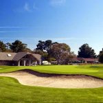 Panoramic view of a lush green golf course at Del Monte Golf Course. Smooth