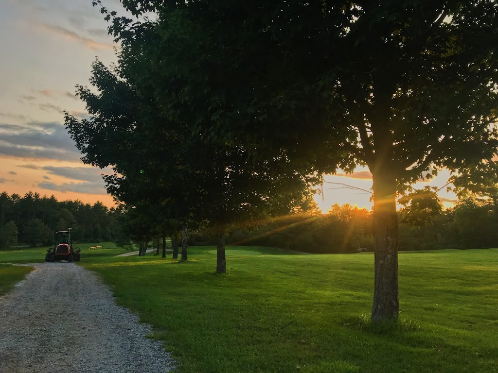 Panoramic view of a lush green golf course at Den Brae Golf Course. Smooth