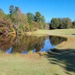 Panoramic view of a lush green golf course at Dogwood Hills Golf Course. Smooth