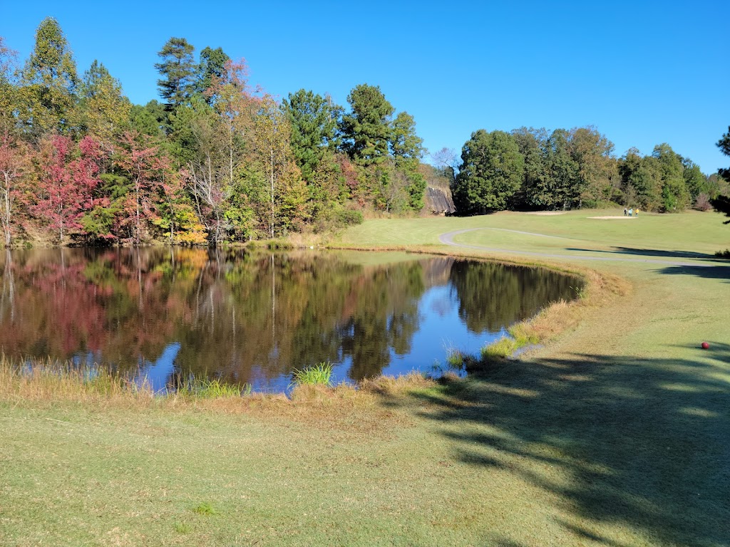 Panoramic view of a lush green golf course at Dogwood Hills Golf Course. Smooth