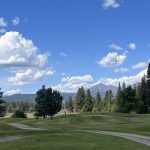 Panoramic view of a lush green golf course at Double Arrow Golf Course. Smooth