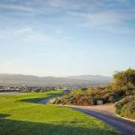 Panoramic view of a lush green golf course at Dublin Ranch Golf Course. Smooth