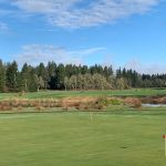 Panoramic view of a lush green golf course at Eagle Creek Golf Course. Smooth