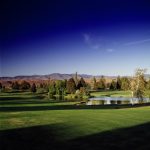 Panoramic view of a lush green golf course at Eagle Hills Golf Course. Smooth