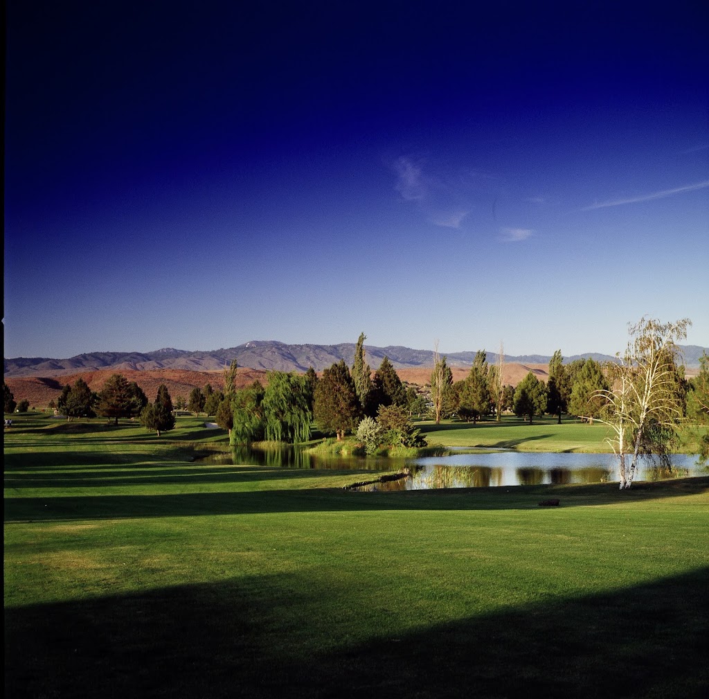 Panoramic view of a lush green golf course at Eagle Hills Golf Course. Smooth