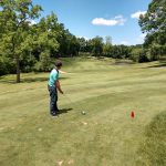 green grass with the flag in the hole.