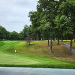 Panoramic view of a lush green golf course at Eagle Rock Golf Club. Smooth