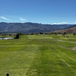 Panoramic view of a lush green golf course at Eagle Valley Golf Course. Smooth