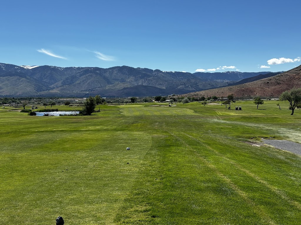 Panoramic view of a lush green golf course at Eagle Valley Golf Course. Smooth