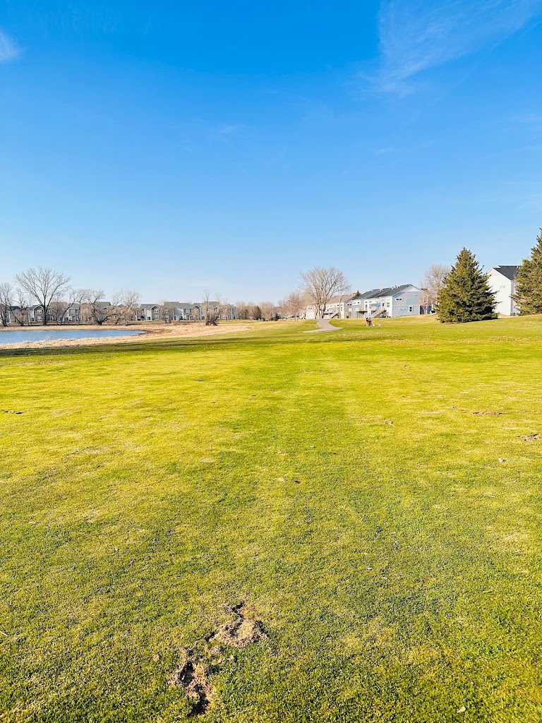 Panoramic view of a lush green golf course at Eagle Valley Golf Course. Smooth