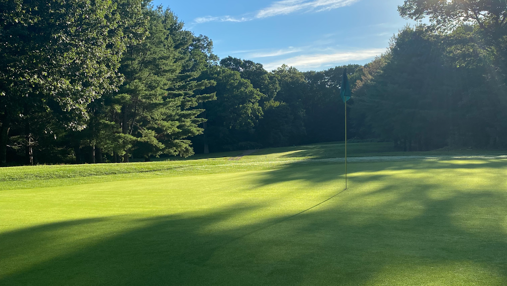 Panoramic view of a lush green golf course at East Greenwich Country Club. Smooth