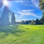 Panoramic view of a lush green golf course at Eastmoreland Golf Course. Smooth