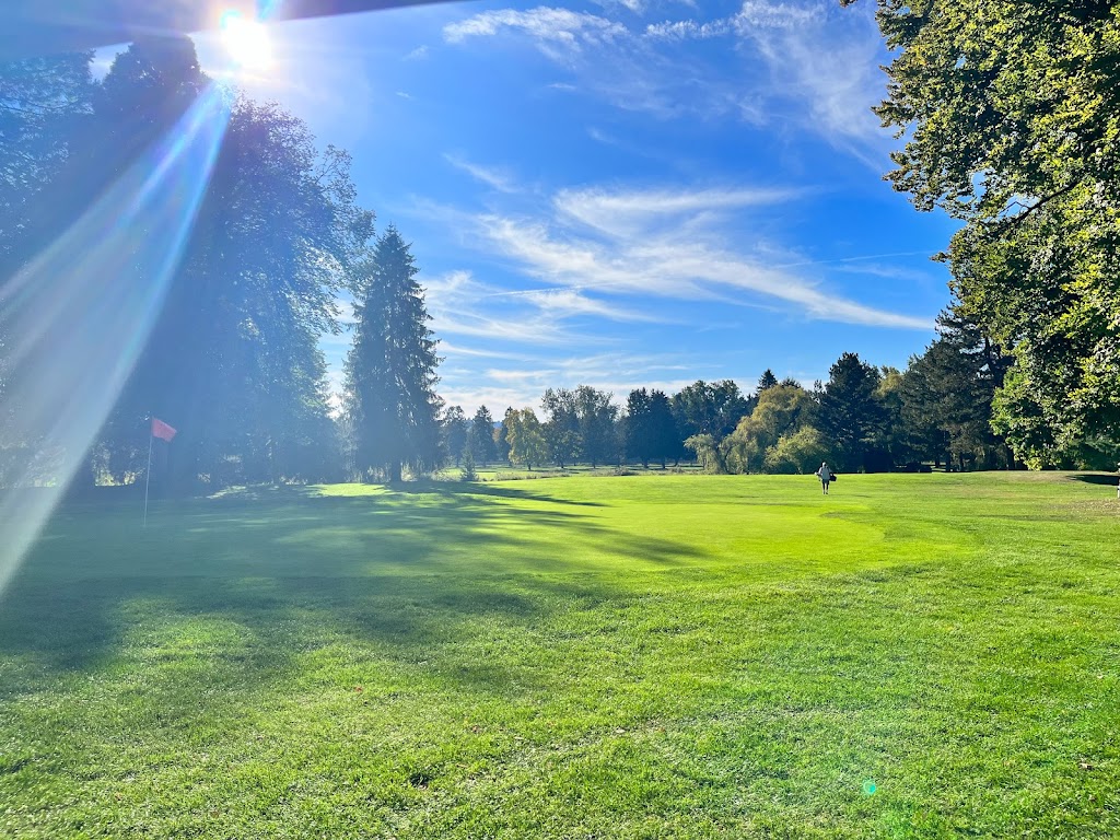 Panoramic view of a lush green golf course at Eastmoreland Golf Course. Smooth