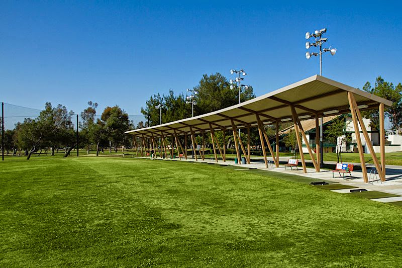 Panoramic view of a lush green golf course at El Cariso Golf Course. Smooth