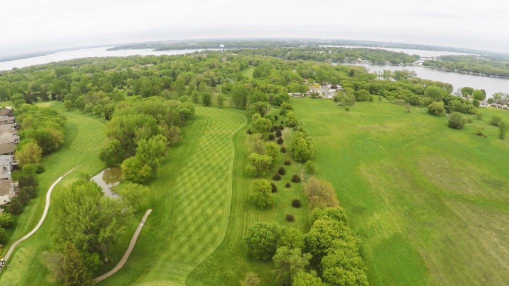 Panoramic view of a lush green golf course at Emerald Hills Golf Club. Smooth